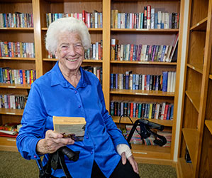 Photo of a woman in a library. Links to Gifts of Life Insurance